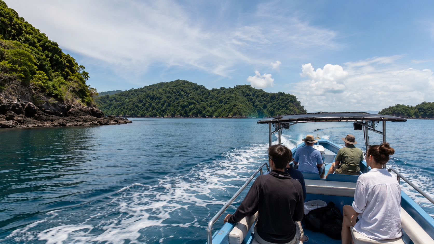 Small boat traveling through Pacific water toward forested islands near Coiba