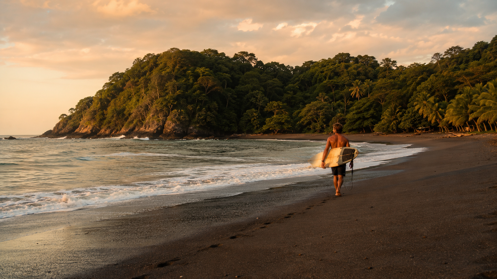 Surfer walking on a dark sand beach in a Santa Catalina surf school inspired visual